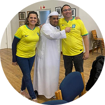 Three learners posing together after a class community event
